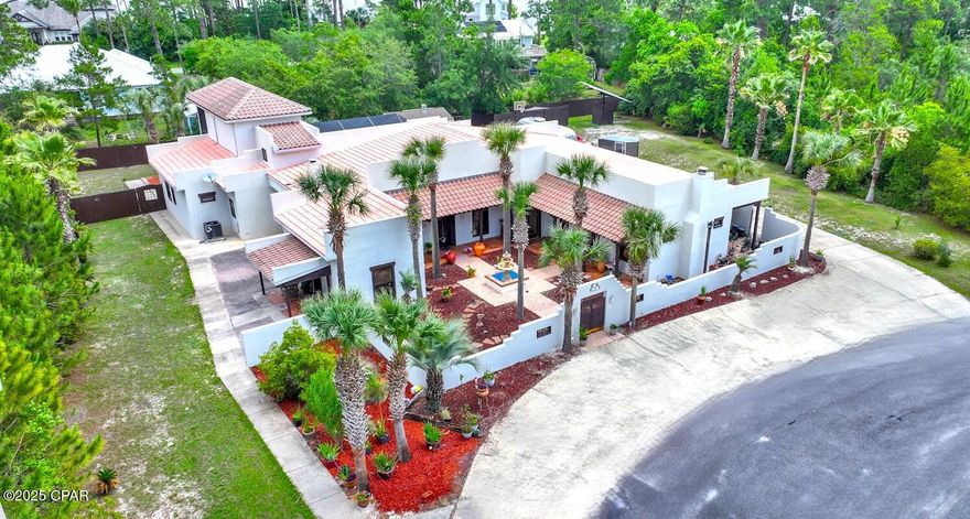 Nestled in the highly sought-after Mack Bayou area of Santa Rosa Beach, this exquisite Spanish Hacienda-inspired estate offers a rare blend of architectural charm, expansive living, and refined indoor-outdoor entertaining - all just minutes from 30A and Grand Boulevard with their vibrant mix of upscale dining, shopping, and coastal lifestyle experiences. Situated on a private road, this thoughtfully designed residence welcomes you through a gated courtyard adorned with a striking double-tiered fountain, setting the tone for the serene elegance found throughout. The home's flowing layout includes a spacious main residence and a private guest wing, ideal for multi-generational living or hosting in style. The main house boasts a grand living room anchored by a

fireplace and custom built-ins, seamlessly connecting to the formal dining area and an oversized chef's kitchen complete with island, breakfast nook, pass-through windows to the lanai, and abundant storage. Soaring glass doors open onto a luxurious screened lanai featuring a pool, spa, and multiple patio spaces perfect for alfresco gatherings.
The expansive master suite is a private retreat with a fireplace, two separate access points to the lanai, a spa-inspired bath with soaking tub and walk-in shower, dual vanities, and a massive walk-in closet. A main-level guest bedroom with private entry and a full bath adds to the home's versatile layout. Upstairs, a charming study-library overlooks the pool and patio area and features floor-to-ceiling bookshelves, a private screened porch, full bath, and generous closet easily convertible into an additional guest suite. The separate guest quarters wing includes its own kitchen, living room with wood-burning fireplace, full bath, laundry, and a private rear courtyard, making it ideal for extended stays or independent living. Additional features include a two-car garage, a detached pool/garden and storage building. This incredible home features a Stone-Coated Metal roof, offering the aesthetic charm of traditional shingles with the exceptional durability of metal. Known for its strength and resilience, this premium roofing system typically lasts 40 to 70+ years, far outperforming traditional roofing!
This elegant residence offers timeless design and comfort with convenient access to the best of 30A and Grand Boulevard. Buyer to verify all dimensions.