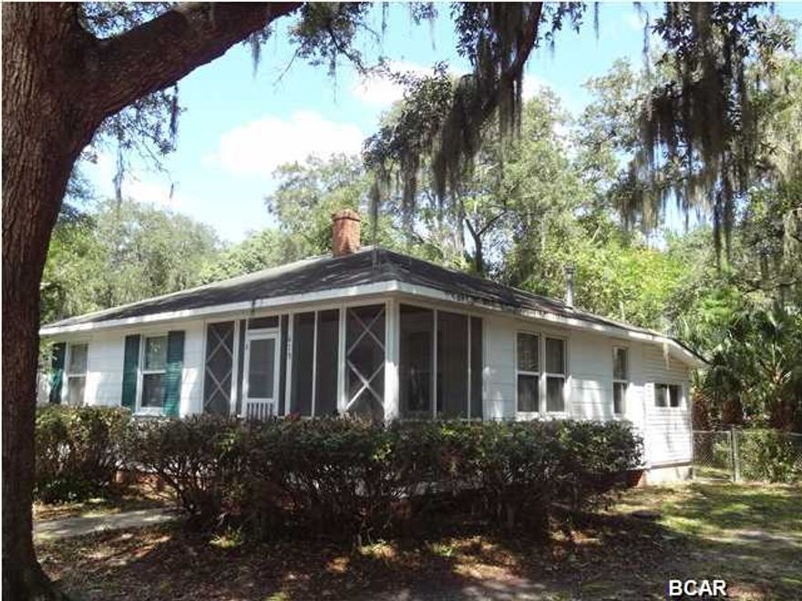 Beautiful home site in ''The Cove'' with magnificent large oaks and magnolia trees. This home is basically a tear down but could be renovated with a little TLC. The value is in this beautiful, very large, fenced in 100x140 lot with an ally way that runs behind the property for easy back access. This gorgeous piece of property could be yours! It is begging for a beautiful home and family, so call today for a showing. Property is an estate sale and being sold AS IS. Buyer should verify all data and dimensions. Square footage is home and porches.