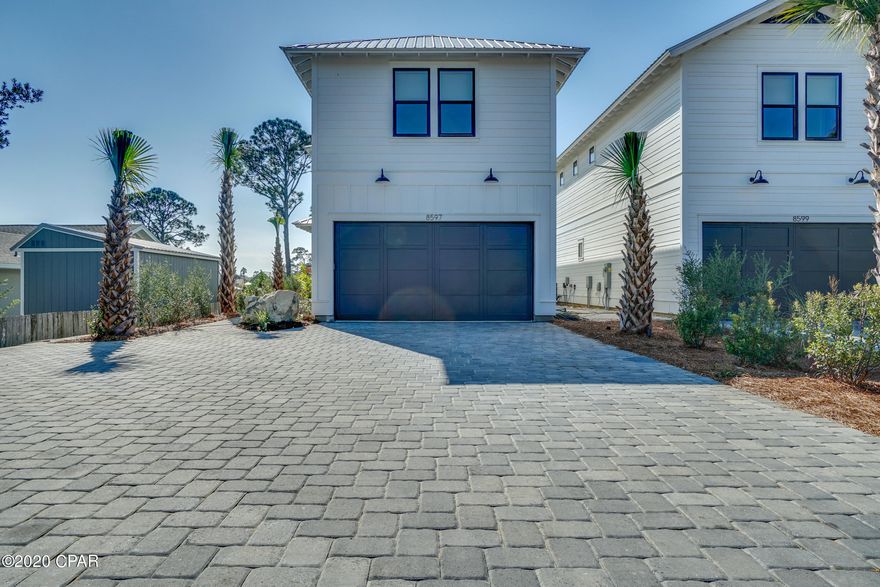 Enjoy sunset views spanning the tranquil waters of North Lagoon in Panama City Beach. This newly constructed home offers 2800 square feet of living space, 4 bedrooms with 3 full baths & powder room. Enjoy waterfront living with easy access to the sugar sands of the Emerald Coast and only minutes from St Andrews State Park, shopping and fine dining. This is a true boater's paradise with a private dock and access to the open waters of the Gulf of Mexico. Fusing urban and coastal styles, this masterfully designed and thoughtfully outfitted residence offers high ceilings, stunning, wet cast stone flooring, open concept living and unique touches throughout. No detail was spared to warm the home, and the heart. Looking across the oversized center island to the lagoon, the epicurean in your life will appreciate the stainless steel appliances, farmhouse style sink and Quartz countertops atop custom cabinetry. Perfectly suited for entertaining or intimate family gatherings, the large open concept living area will be the perfect location to make memories and enjoy the coastal lifestyle. 

The master suite offers the perfect retreat after a day of boating or playing along the shores of the Gulf, with ensuite. Each additional guest suite will be a welcome respite for friends and family. A large bonus room and private covered balcony complete the interior of the home.

The lifestyle is complemented by the private boat dock just beyond the peacock paver deck surrounding the pool. The outdoor entertaining area is completed with a synthetic turf backyard for ease of care and year-round beauty. Other notable features include: 8-foot solid core interior doors; brushed nickel fixtures; LED landscape lighting; one-car garage and boat dock.