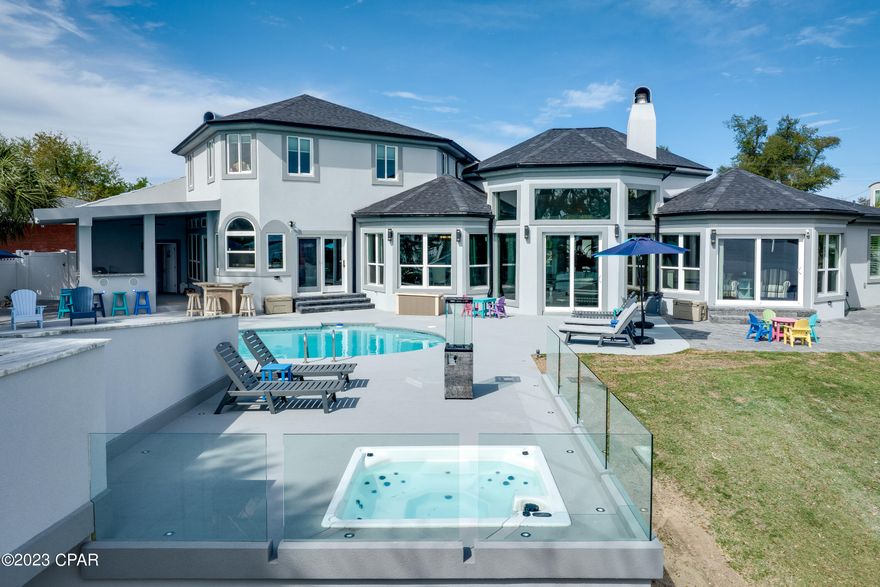 CURRENTLY UNDER CONTRACT, SELLER WILL CONSIDER BACKUP OFFERS **STUNNING WATERFRONT IN THE COVE** This luxurious 6BR/7BA bath home is loaded with recent upgrades and is located on the prestigious Bunkers Cove Road in the historic Cove area of Panama City, and offers the best of Florida living. From the moment you step inside, you'll be greeted by a light-filled living area and breathtaking waterfront views. With three bedrooms on the ground floor and three upstairs, this home provides ample space for family and guests. The impressive outdoor space is just as stunning, featuring a waterfront pool and hot tub, outdoor kitchen, bar, and a 300'+ dock. Imagine enjoying an evening cocktail on the deck, watching the sun set over the water, or hosting a poolside barbecue with friends and family. Make it a point to see this stunning home today. JET SKI LIFTS DO NOT CONVEY.