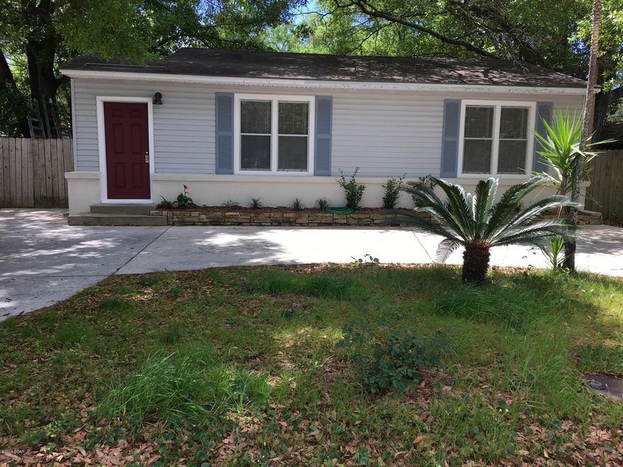 Cute  Florida Cottage, 2 bedroom, 1 bath, office, large laundry room, new kitchen, bath has been completely remodeled . New paint throughout. Lot has large trees and fenced back yard. Very large garage/workshop , 12 X 24 Bestway building and additional storage shed. Located directly Accross the street from Lucille Moore Elementary. Private lot.   ...no other houses face this one. Vinyl siding with stucco over brick....circle drive.
