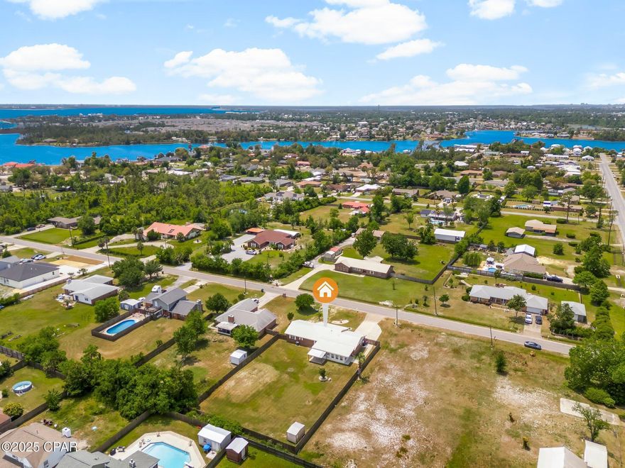 'CURRENTLY UNDER CONTRACT, SELLER WILL CONSIDER BACKUP OFFERS' 

Welcome to this beautifully maintained 3-bedroom, 2-bathroom brick home situated on a generous lot that offers both space and privacy—with no HOA and no lender-required flood insurance for added peace of mind. With a 2-car garage complete with built-in shelving, this property is perfect for families, hobbyists, or anyone looking for room to grow.

Step inside to find a large living room with a cozy wood-burning fireplace, ideal for relaxing evenings. The updated kitchen features an abundance of wood cabinetry, a breakfast nook, breakfast bar, and an eat-in dining area—perfect for entertaining or casual family meals.

All three bedrooms are oversized, providing plenty of room for rest and relaxation. You'll also enjoy the convenience of a spacious laundry room with additional cabinetry, offering excellent storage and functionality.

Retreat to the large privacy-fenced backyard, which includes a covered patio, a shed, and plenty of room for gardening, pets, or outdoor activities. The oversized sunroom is both heated and cooled, allowing for year-round comfort, while the large screened-in front porch provides another great space to enjoy the outdoors. Plus, the property includes an irrigation well to help keep your landscaping lush and green (un-used currently).

Additional highlights include a new HVAC system, new water heater, All new kitchen appliances as of 6/2024, well maintained and cared for, ample parking for cars, boats and RV gate, a durable metal roof for long-term reliability, and a layout that combines comfort, character, and practicality.

Conveniently located only 8.7 miles from Tyndall Air Force Base, 16 miles from the Navy Base, and 23 miles to Panama City Beach, this home is perfectly situated near key destinations.

Don't miss your chance to own this warm, inviting home with room for everything and everyone—without the extra costs or restrictions!