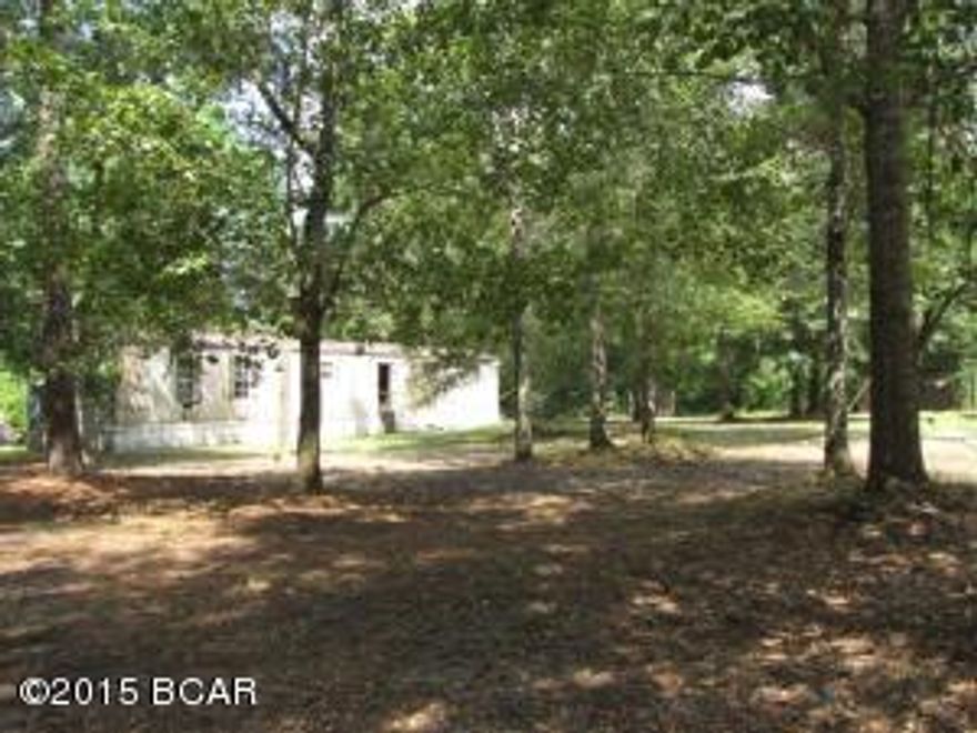 LEVEL LOT OF OVER 1/2 ACRE ON PAVED ROAD   Conveniently located just off Hwy 231 in the Fast Growing area North of Panama City. Lot has Old Mobile Home which should be considered uninhabitable and valued for Scrap only. Lots of Nice Pretty Trees, existing Electric, Well, and Septic make it favorable choice for a new Mobile Home, Modular, or Site Built Home. Possible Seller Financing available.