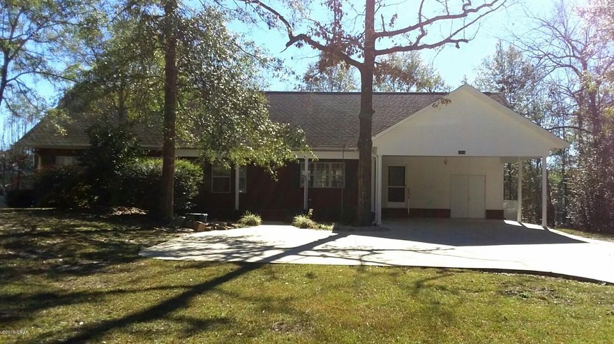 Bright and spacious living room with cathedral ceiling and corner fireplace. 1724 h/c SF with 2580 total SF under roof. The open floor plan includes a kitchen with eat-at island and dining area with bay window. The foyer area has a large coat closet and a stained glass window. The wood laminate flooring looks very nice with this open concept. Both bedrooms are carpeted with the Master BR having a large stained glass window feature and a wood deck onto the back yard. The roomy master bath has a whirlpool bath and separate tile & glass shower. The screened porch off the living room is a great place to enjoy those pleasant days and nights. Nice concrete drive with 2-car carport, extra parking and utility room. A beautiful home!