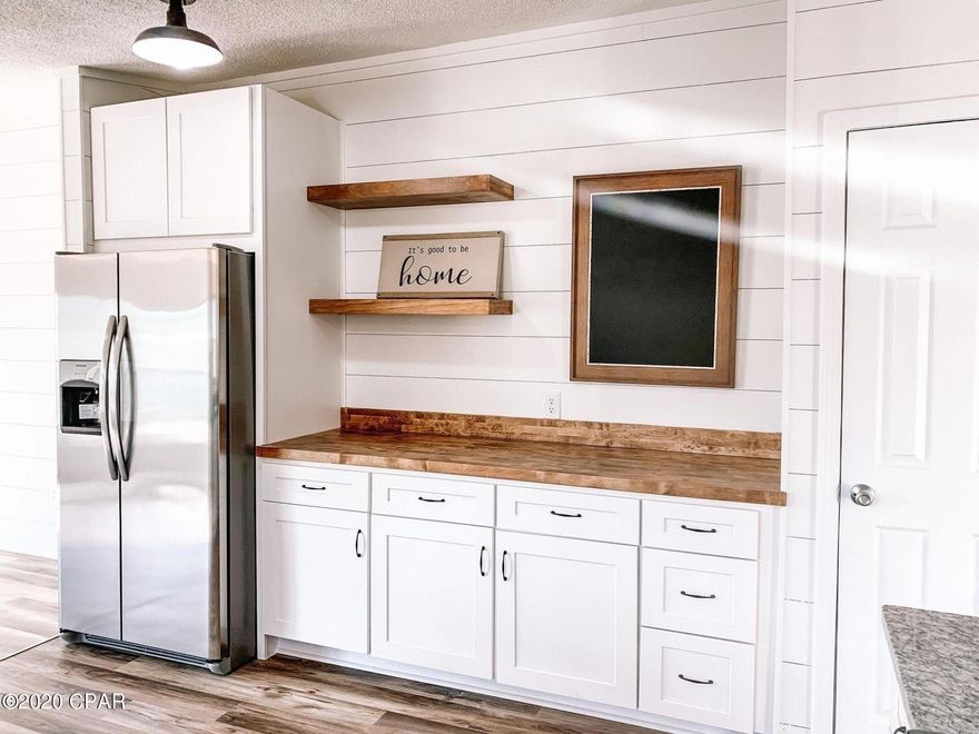 Beautifully updated home! Freshly painted shiplap with a modern farmhouse theme standout as you enter the front door into the open concept living/dining room w/ real wood burning brick fireplace! The kitchen is huge w/ brand new cabinetry, granite and genuine butcherblock counters and new stainless steel appliances. The kitchen leads into a bonus family room that is spacious and completed w/ fresh white shiplap. The split floorplan continues w/ a beautiful Master Suite with dual vanities on one side and two good sized bedrooms and a bath on the other. The laundry/mudroom w/ bench and backpack hooks leads out to the back deck where your family can BBQ and entertain while watching the kids play in the large backyard with new sod and out building!