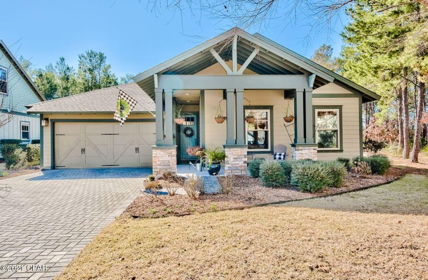 This Wild Heron home offers spacious living areas, craftsman finishes, and access to exquisite neighborhood amenities. A quiet retreat, this home is tucked on a .37-acre lot and backs up to the nature preserve and the golf course. Well maintained, this single-story home features a split floor plan and high-quality design. Inside, an abundance of natural light flows through open living areas. The living room offers a beautiful coffered ceiling, while the kitchen provides an inspiring place to prepare meals with its granite countertops, large island, a pantry and ample cabinetry. An eat-in kitchen area overlooks the surrounding trees in the backyard. A centrally-located dry bar allows for easily preparing and serving drinks, and a separate formal dining room provides plenty of room for hosting family and friends. Four spacious bedrooms offer comfortable accommodations, and the master suite includes a luxurious spa with a tub, walk-in shower, and double vanity. Recent upgrades include a screened porch, landscaping, dry bar with wine cooler, new tile flooring, new interior paint, and new carpet installed in the bedrooms. Additional features include a two-car garage with extra storage space. Main living areas lead out to an expansive screened in porch with room for outdoor dining and entertaining. Plumbed for natural gas, create the outdoor kitchen of your dreams or utilize the large backyard to create an outdoor oasis with a private pool. 

Living in Wild Heron offers access to several exquisite lakefront amenities on Lake Powell, including a heated pool, hot tub, fitness center, two docks and a boathouse filled with water toys for that quick paddle to the beach. Additional amenities include a fire pit, playground, gazebo, and 24 miles of walking and biking trails. Golf and tennis memberships are also available for purchase. Surrounded by a 734-acre coastal sanctuary and the famous Greg Norman Sharks Tooth golf course, Wild Heron is a tranquil retreat that is only a quick drive from infamous white sandy beaches of the Gulf of Mexico, 30A and popular shopping and dining destinations.