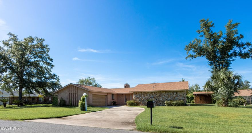 Price improvement for this charming and well-cared for home in Panama City.  Sitting on a nicely landscaped oversized lot, this 3-bedroom, 2-bath brick home has an impressive 15 X 22ft living room with a stone fireplace and bar area providing a generous amount of room for entertaining. The updated kitchen has plenty of cabinets, a breakfast bar, and built-in kitchen table. The bedrooms are all nice size, and the master bedroom offers a dressing area and walk-in closet. The large office has plenty of room for teleworking and/or homeschooling or it could easily be a 4th bedroom. The recently remodeled Florida Room is heated and cooled and opens to a beautiful paver patio. The detached 605 square foot mother in law cottage has its own kitchen, dining area, living room, bedroom and bath.  It also has washer/dryer hookup in place.  

Notable features include concrete and steel beam roof construction in main house, an irrigation system, and a She Shed/He Shed/workshop. The two-car garage and second driveway allow for plenty of parking.  Boat storage is no problem and Shoreline Circle Boat Ramp with Bay access is conveniently located a few blocks away.