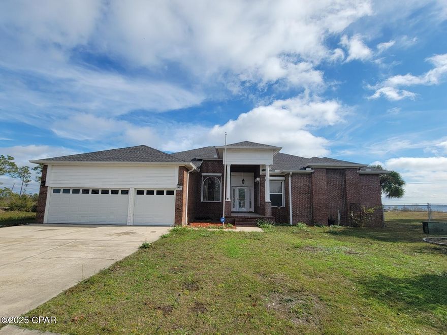 Waterfront Living with a small Private Beach! Welcome to Callaway Point - This beautifully custom-built brick home offers serene waterfront living with access to a small private beach, right from your backyard. Boasting 4 bedrooms, 2.5 baths, and a spacious open floor plan.  Features include 3 car garage, custom design interior with high ceilings, crown molding, and a mix of hardwood flooring, ceramic tile, and luxury vinyl plank., The kitchen features custom cabinets with glass shelving, granite countertops, and pantry. The kitchen comes equipped with refrigerator, range, microwave, and dishwasher. Just off the kitchen, there is laundry room, and service door leading to the garage. The master bedroom is very spacious and features hardwood flooring with access to the Florida room. The master bath has large ceramic tile shower, a whirlpool tub, double vanity, and double walk-in closets.
On the opposite side of the home, there are 2 large additional bedrooms that share a full bath with ceramic tile shower. 
The 4th bedroom is located off the family room and could be utilized home office or playroom. It is has direct access to a half bath. Off the dining area, are French doors leading out to a large Florida room which is great versatile space that can be used as a den, home office, gym, or game room. Within a few steps, head out the 12X40 screened porch where you can relax and enjoy outdoor dining and stunning views. The backyard is fenced and there is a storage shed for tools and equipment. The home was built with steel studs, and all the windows are equipped with ''easy to use'' hurricane shutters. 
This home is convenient to local amenities- schools, shopping, restaurants, local parks, Tyndall AFB, Mexico Beach and much more! This is a peaceful retreat, and is the perfect place to call home. Don't miss out on the opportunity call today!