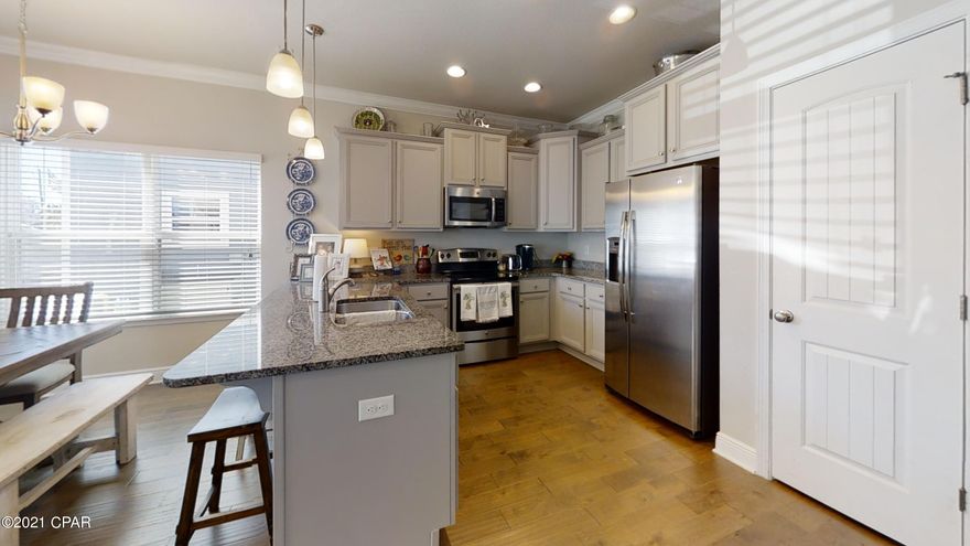 CURRENTLY UNDER CONTRACT, SELLERS ACCEPTING BACKUP OFFERS. You don't want to miss this beautiful well-maintained 4 Bedroom 3.5 Bath in the bay front gated community of Magnolia Bay Club. You are just a short stroll down the sidewalk to the sandy white shoreline of the Bay. Open concept living area, dining and kitchen showcases beautiful cabinetry, granite counter tops, stainless steel appliances and breakfast bar.  Home features two master suites, one upstairs and one downstairs.   Downstairs has it's own full bath great for guests or mother-in-law suite.  Upstairs master offers it's own private balcony and 2 walk-in closets.  En-suite offers dual vanities, tiled shower, and tub.  Spacious additional bedrooms and lots of storage. Community amenities include heated pool and tropical deck. sandy bay-front beach, kayak storage, fitness center, community room, grand bay gazebo, sidewalks, playground, & fishing dock.  New roof in 2019 and home has been freshly painted.  Enjoy this exclusive way of life with endless activity of Florida's famous sugar-white beaches just minutes away.