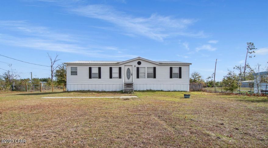 2005 Mobile home located in Bayou George with upgrades. Settled on a mostly fenced 1 Acre lot on a county maintained road. Lot is mostly cleared. Plenty of room to add more buildings on property, or storage. There are many boat ramps in the nearby area for fishing. Close to stores for grocery, gas and a new dollar store. This home has been professionally leveled. New fencing and gates, new water pump and water softening system all enclosed in well house. 

30 min from Tyndall, 45 min from Panama City Beach. 3 minutes to Jaycee Ballpark. Financing options are available. Home should have no issues with financing due to good maintenance and work already done.