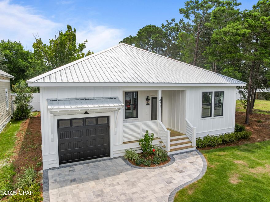 Welcome to 471 Paradise Blvd. Located on the west end of Panama City Beach in the darling gated community of Paradise Grove. This home is a short golf cart ride away to the beach, close to all of the areas attractions and a short drive to the iconic 30A. This stunning new construction home offers 3 spacious bedrooms, 2 full bathrooms, and a 1-car garage. This thoughtfully designed residence blends safety, quality, and custom craftsmanship.

Built to meet all Florida hurricane requirements, this home provides peace of mind while showcasing beautiful custom details throughout. The open-concept living area is elevated with a stained ceiling, pecky cypress beams, and elegant finishes that make every space feel warm and inviting.

Enjoy a modern kitchen with custom cabinetry and an easy flow into the living and dining areas, creating the perfect space for entertaining or relaxing with family. The primary suite offers comfort and style with a private ensuite bath, while the additional bedrooms provide flexibility for family, guests, or a home office.

From its hurricane-rated construction to its unique custom touches, this home embodies both durability and elevated design—an exceptional opportunity to own in the lovely gated community of Paradise Grove.