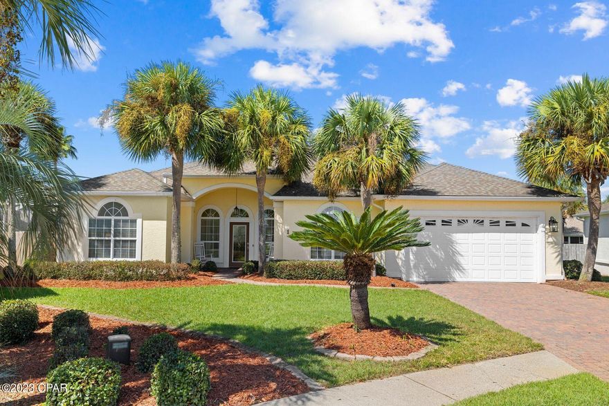This fabulous pool home sits at the end of a quiet cul-de-sac and is just a three-minute walk to the beach. Four beds and two baths make this a spacious primary residence or second home for beach lovers. Dive into the pool for a refreshing swim before enjoying a leisurely breakfast on the terrace, all within a huge screened mansard. The front yard is landscaped with a grassy lawn and paved driveway leading up to the two-car garage. There's plenty of room for family and friends to park when entertaining. The light, bright living room has huge picture windows, neutral tile flooring and a feature gas fireplace with built-in shelving on either side. Fully furnished, this single-family home has a formal dining area as well as a breakfast nook adjoining the attractive white kitchen. New stainless appliances contrast with the dark granite countertops, making this an excellent space for creative cooks. A host of cabinets provide ample storage along with the pantry and laundry. The split floorplan includes a spacious master bedroom with its own huge bathroom complete with corner tub and walk-in shower. Two further bedrooms, a family bathroom and a bunk room provide ample space for everyone to spread out. Families will appreciate the additional bonus/TV room providing access to the rear yard with its amazing freeform pool and spa. Wooden security fencing provides ample privacy in this easy-to-maintain outdoor space. Recent updates include a new roof and water heater (2018), pool pumps, pool heater, HVAC and lawn irrigation system. This spacious home is in a non-rental neighborhood just a short stroll from public beach access. It's surrounded by great amenities including schools, supermarkets, restaurants and attractions lining Scenic Highway 30A. Nearby Pier Park completes the lifestyle with premier shopping, dining and entertainment.