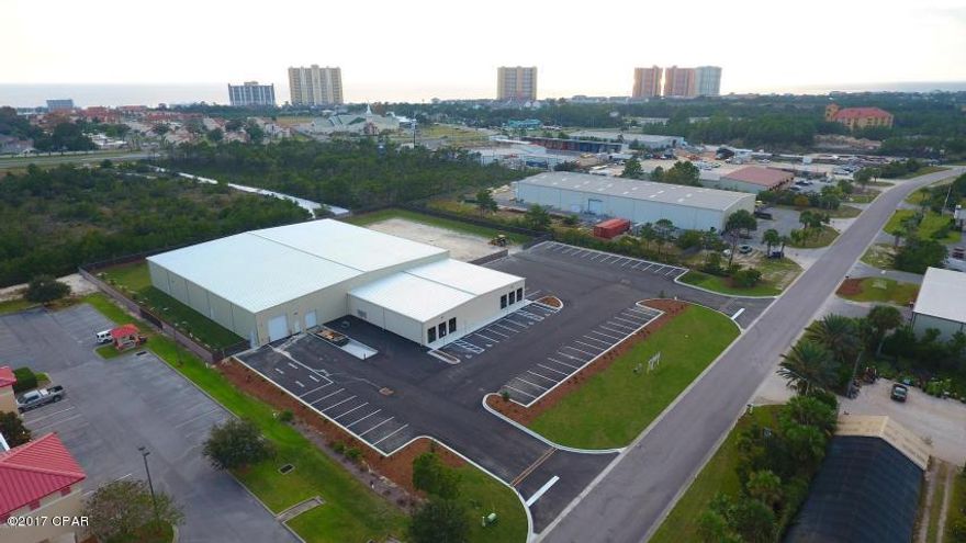 If you are looking for a large industrial building with lay down yard located on Panama City Beach, you just found it! 28,620 Sf industrial warehouse with 6,120 SF of office and a large 170 Ft x 95.2 ft. (.37 acre) lay down area.  Building can be divided into two 14,310 SF spaces with 11,250 SF of that warehouse space and  3,060 SF of office space. Warehouse has 20-foot eave height clear span. Office space has 14' eave height. Each separate space of building will have dock high and ground level loading dock with 12' x 14' roll-up doors. Office space- HVAC, 3,060 Sf, 14-foot ceiling heights, and multiple restrooms, glass frontage and doors. 100% Fire protected and high efficiency lighting throughout. This building is expected to be completed October 2017. This building is located in the Beach Commerce Park, the only industrial park on Panama City Beach, near all of the growth in South Walton and Panama City Beach and less than 10 miles from the Panama City Beach Airport and the 30-A / South Walton corridor.