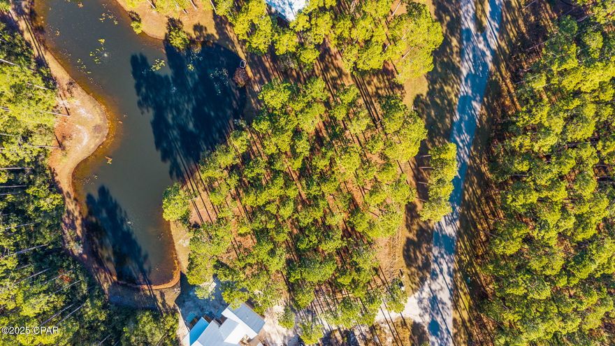 WATERFRONT LOT IN RIVERCAMPS:  Make your new home in RiverCamps—Panama City Beach's premier waterfront preserve community with 1,500 acres of natural beauty and over 1,000 acres of it dedicated to conservation. This homesite sits on a peaceful POND with full WATER views, offering one of the most desirable settings in the neighborhood.  This particular pond only has five homesites around it and backs up to some of the preservation area.

RiverCamps is bordered by Crooked Creek, West Bay, and the Intracoastal Waterway, with a private community boat ramp providing quick access to the Gulf. Enjoy endless outdoor activities including boating, fishing, paddleboarding, hiking, and birdwatching across miles of preserved trails and shoreline.

Amenities include gated access,zero-entry pool and pavilion,  day-use boat slips, dry storage, pickleball courts, campfire/glamping tents, and a new fitness center coming in 2026. Located just minutes from the new hospital, world-class beaches, and Pier Park, and the Northwest Florida Beaches International Airport (ECP).  RiverCamps offers unmatched tranquility with exceptional convenience.