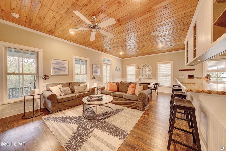 One of the lowest priced homes on 30a with deeded beach access. This stunning Florida Cottage is the most desirable floor plan, the Cedar Key floor plan. Beautifully constructed and primely located just steps from deeded beach access, this exceptional 1,225 square foot, three bedroom home features premium finishes with unparalleled interior design and professional decor. Characterized by Florida coastal cottage design, this charming coastal retreat makes the perfect secondary home with easy beach access and great short term rental opportunity (home easily sleeps 6 people). Notable features include custom wood ceilings, granite countertops, stainless steel appliances, washer/dryer included, hardwood floors, solid wood cabinets, weathershield windows and doors, outside shower, screened porch, and custom stored onsite storm shutters with quick connect fasteners.
The chef's kitchen masterfully anchors the spacious open floor plan and is finely appointed with a beautiful electric range, stainless appliances, custom cabinetry with ample storage as well as a sizable center island which is perfect for entertaining. The chef's kitchen is open to the gorgeous living room and dining area which feature custom lighting, custom built-in entertainment center, and plenty of seating. Other notable features include a large master suite as well as two additional bedrooms with their own private bathroom. Each room offers additional space for entertaining, and a private laundry which makes it perfect for multiple families gathering in one place. Situated on a nice sized lot with trees and foliage, this home is central to all of the world class amenities in Seacrest including the private Magnolia by the Sea pool, private/deeded beach access (both the beach and pool have private codes) as well as close proximity to many other activities with its eastern positioning.