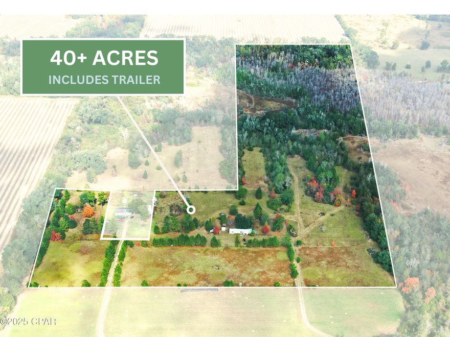 40 acres in the Country with a mobile home thrown in!!    This parcel is fenced and crossed fenced in some sections.  Open in others.  The property has power (West Florida Electric) water (well water) and septic.   Great for recreational activities such as hunting, horseback riding, ATV or just to get away.   The mobile home is livable as a main home or used as a camp to retreat.  The land has a mixture of trees, nature areas as well as pasture.   Many opportunities are ahead for whoever sees the vision first.   Call today!!