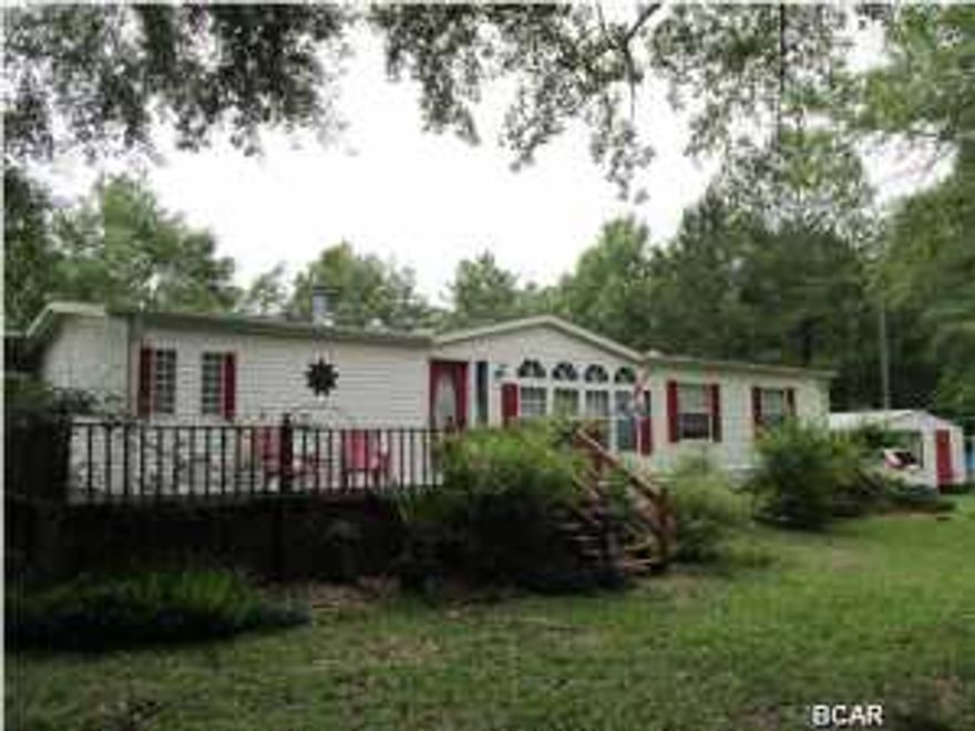 Beautifully maintained Triple Wide manufactured home on 10 manicured, country acres. The 2100+sf home is open and spacious. The rooms are HUGE! The pictures do not do this home justice, you need to see it to appreciate just how spacious this home is. Eat breakfast while watching the birds and squirrels feeding underneath the massive archway of Trumpet flowers and Jasmine. The enclosed deck is perfect for barbeques year 'round. Take a walk around your own pond filled with bream. Watch the deer eat at the back of the property. Nature galore! And located a block away from the Piggly Wiggly and Family Dollar. You'll only have to drive the 30 minutes to Panama City when you're needing some beach time. Make your appointment today!