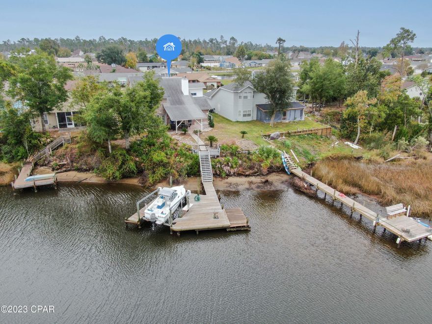 WATERFRONT WITH BOAT DOCK AND LIFT!! Take a look at this beautiful brick home on Callaway Bayou WITH GULF ACCESS!  This home features 2 master bedrooms. One downstairs and one upstairs.  The 20' ceilings allows lots of natural light and the hurricane rated, energy efficient windows help keep the utility bills low. Centrally located in Callaway, a 10 minute drive to Tyndall AFB and 10 minute drive to Hwy 231. This is a beautiful home just wating for its next family!