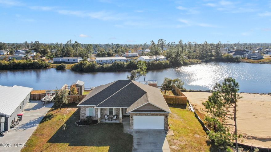 Waterfront 3 Bedroom 2.5 Bath Home! This home is a fishermen and child's dream. It comes with an Open Floor Plan, 3 spacious bedrooms all with walk-in closets, Hardwood, Tile & carpet, neutral wall colors, trayed ceiling in the living room and Master Suite. The Kitchen comes complete with all stainless steel appliances, granite counter tops, hardwood cabinetry, breakfast bar, dining area & pantry! The master suite provides a gorgeous lake view, large bathroom featuring double sinks, beautiful custom built-in in the living room, 5 ft separate shower, whirlpool tub, private potty room, His & Her Walk-in Closets. Separate Laundry Room, big screened in porch, shed, fenced in yard, dock to catch all the fish you could imagine, and a playhouse your children or grandchildren will adore!