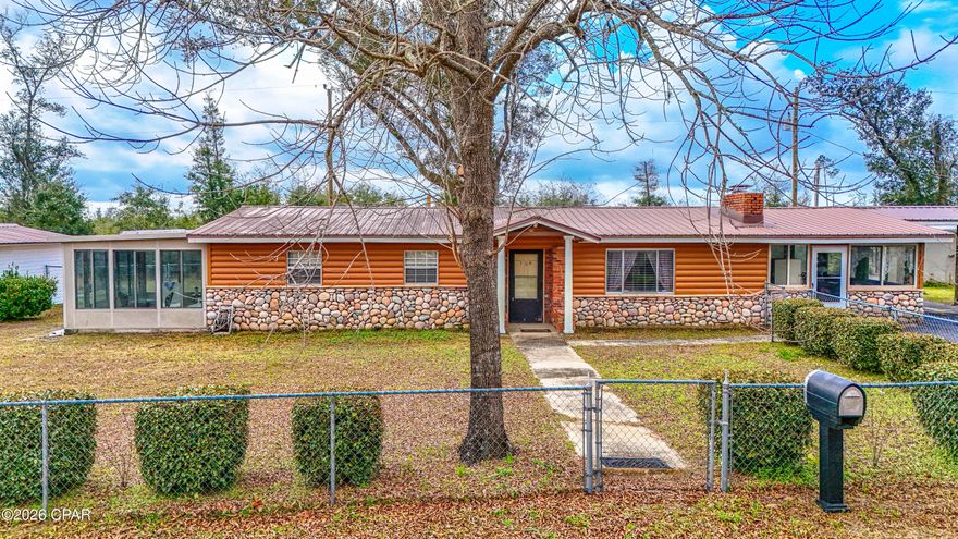 What began as a manufactured home has been tastefully and professionally expanded to create an appealing residence. The exterior features an attractive combination of vinyl and stone. The additions include a sunroom, an oversized Florida room, a screened room, and a covered carport. The property also includes a spacious 14x26 workshop. The front yard is fenced and features several fruit trees.  A public boat ramp is located just one block from the house, providing access to Deerpoint Lake, making it a must see for fisherman looking to get on the water. The home has a metal roof, a solid newer heating and air conditioning system, and a recently updated exterior breaker box and exterior electrical supply lines. Water is supplied by an onsite well, and the sewer system operates on septic. This is a wonderful opportunity to own an affordable home centrally located in Bay County.