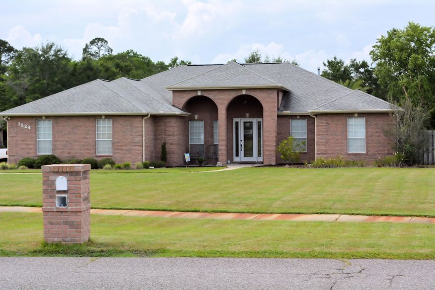 In a word, WOW!! best describes this exceptional Mowat Highlands home! From the stately all brick exterior, to the beautiful custom interior features, to the awesome in ground pool and finally to the outdoor living area with summer kitchen, this home has everything you ever dreamed about. Custom built by one of the area's top builders, this home features built-in cabinetry, archways, and loads of trim moldings. As you enter the home you are met by a huge welcoming foyer. From here, you'll notice the home office to the right and a large fromal dining room to the left. The main living room offers a built-in entertainment center, fireplace, and high ceiling with recessed lighting. The large eat-in kitchen is complimented with granite counter tops, maple cabinetry and built-in china hutch.