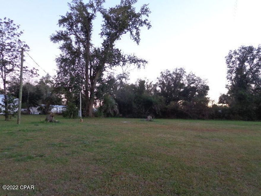 Half Acre located in the City Limits of Grand Ridge.  Close drive to both Hwy 90 and I-10.  

Utilities in place.  Old building on property that was being used as a workshop/storage.