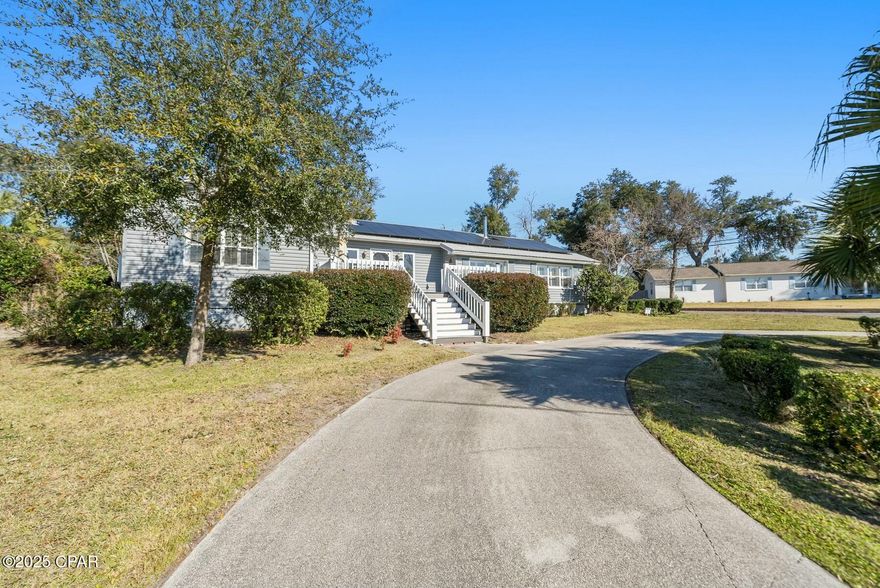 This charming Cove home with a water view is on a huge corner lot with over 1/3 acre,  Brick with vinyl siding and includes a 25x25 garage, and workshop, garden shed, fireplace, hardwood floors, crown molding , plantation shutters, lots of natural light and so much more! This home is just a short golf cart ride to the St Andrews Yacht Club, coffee shops, waterfront restaurants , a library , Martin Theatre, Art Museums, marinas and amazing places to spend leisure time in downtown Panama City. No HOA or flood insurance required, the lot sits high! Schedule your showing today!