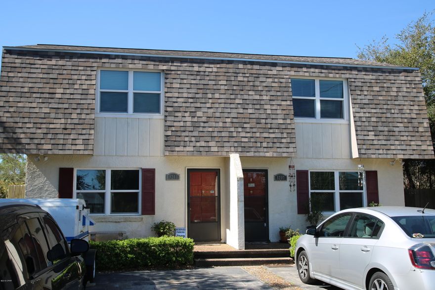 Hear the waves at night! Awesome chance to purchase an income producing duplex! Both sides have leases! Each unit has an open floor plan, galley kitchen, w/ 2br/1.5 baths. The back yards are the BOMB!! They are fenced, have a shared shed, and newly built decks!! Windows, roof, both replaced last 2 years. Not only can you walk to our GORGEOUS WHITE SANDY BEACHES, you are across from GRAND LAGOON!!!! Duplex was conected to city water and sewer 2 years ago!! Location is FANTASTIC, quiet street, yet close to everything! Call your favorite Realtor to see this one!! Dimensions to be verified by Buyer.