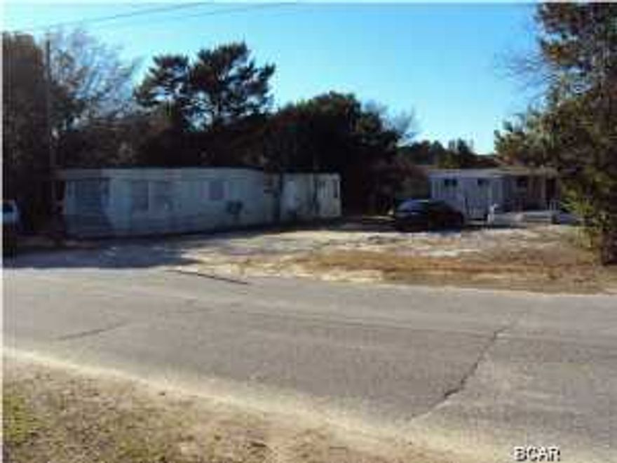 An INVESTMENT OPPORTUNITY. This is worth looking into as a Rental AS IS or building town homes or duplexes. The seller is selling 309 Paridiso also.for the same price of $74,900 MLS#628529 Straight walk to dedicated beach or close to shopping at Publix or Winn-Dixie on the West End. The growth from Walton County is coming this way so be ready this is a great price for the land and the investment you can do a lot with such a big piece of property. Don't miss out on this great deal. Hardware Flooring throughout. Thank you