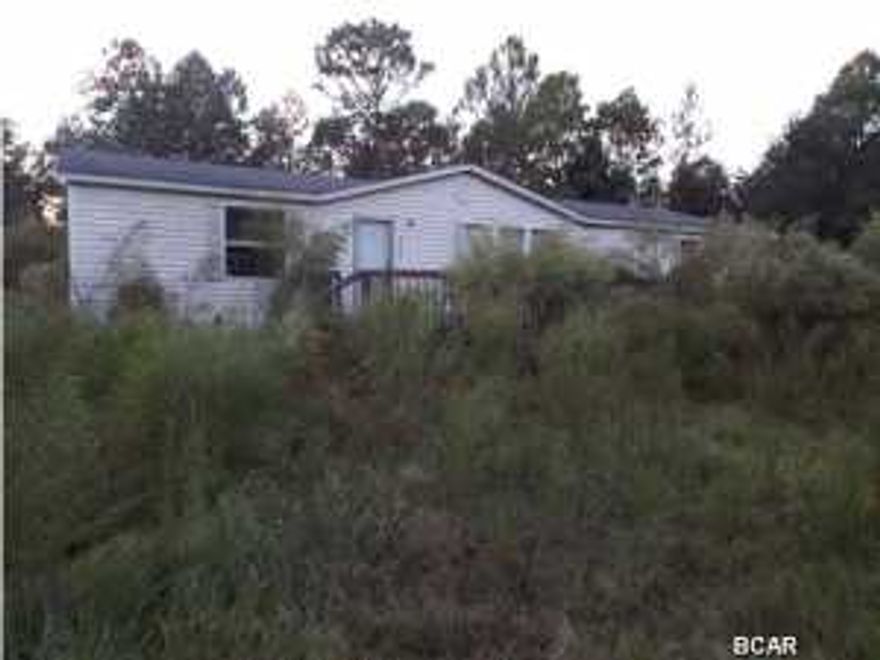 1800 square foot 2004 model, Three bedroom two bathroom Manufactured house with a 1974 two bedroom, one bathroom single wide both needing some TLC on an acre lot offered as is. All sizes approximate please verify accordingly.