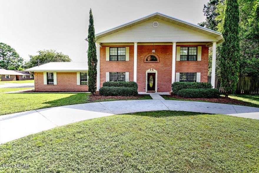 LARGE 4/3 + OFFICE w/ MOTHER-N-LAW QUARTERS; New Paint, Carpets, Bathrooms and Fixtures. This Colonial-style 2-story home complete with 4 massive front columns has a formal living room, formal dining room, kitchen w/ breakfast bar & breakfast/dining area, a large Florida room [not counted in sqft], a den/family room with large stone hearth/gas fireplace, and a separate office. The garage was enclosed to make a large bonus room or Mother-n-law quarters with it's own adjacent bedroom & bath. It also has a private entrance & its own separate A/C unit. The backyard has one yard buildings and is completely fenced. Plenty of parking with a widened side entrance driveway AND a circular drive off State Ave. Convenient to everything on 23rd street- shopping, restaurants, etc.
