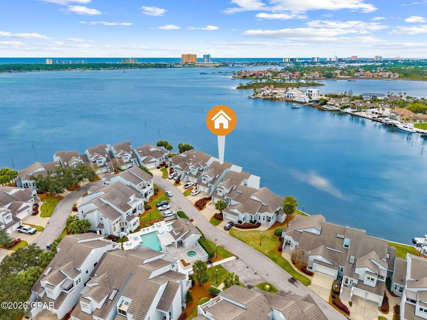 Experience the best of coastal living in this beautifully appointed 2-bedroom, 2-bathroom Waterfront Condo located in the prestigious gated community of Bay Point. Offering stunning water views and unforgettable sunsets, this residence is designed for both relaxation and entertaining. Inside you will find a spacious, light-filled interior featuring soaring lofted ceilings and an open-concept layout. The well-equipped kitchen includes a built-in oven, microwave, and wine fridge, perfect for hosting or enjoying quiet evenings at home. It connects to a space that can be used as a sitting room, breakfast nook or office space with its own covered balcony overlooking the pool. The spacious living/dining area leads the way to the large balcony, perfect place to enjoy your favorite beverage while taking in the tranquil view of the bay. The Waterfront Primary suite with balcony access and a walk-in closet will have you feeling like you are walking on water. Enjoy the luxurious ensuite bathroom offering a dedicated tankless water heater, spacious walk-in shower, double vanities with ample storage and natural light. The second bedroom and bathroom are located on the other side of the condo, offering privacy to you and your guests. This condo has a one car garage that includes 2 additional storage areas. Marina Club Residents enjoy access to the sparkling community pool and hot tub. Bay Point is home to the only Nicklaus designed golf course in Northwest Florida and a full-service Marina, Point South. Take a short stroll to the Clubhouse, Marina, and local Bar/Grill for dining and socializing. Bay Point is not just a neighborhood, it's a Lifestyle. Contact your favorite Realtor today to learn more and schedule a showing!