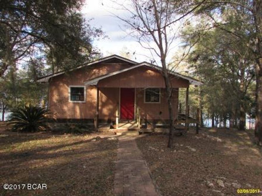 WATERFRONT home in Leisure Lakes!! 3 Bedroom 2 Bath home with 1176 sq. ft. Relax in the gazebo overlook the  lake on almost a 1 acre lot!! Unfinished wrap around deck, but with some vision this home can be your perfect Getaway! Wood Floors with an Open Floorplan.  Only a 30 minute drive to the Worlds Most Beautiful Beaches in panama City! Home to be sold AS-IS.
