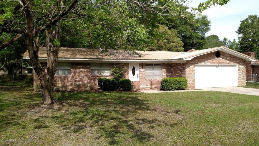 This home has great bones!  All brick exterior with new metal roof.  The interior needs some cosmetic updating, but everything is still in great shape.  There are two nice sized living spaces with a real wood burning fireplace in the den, along with 3 bedrooms, and two baths.  The lot is huge with a fenced back yard.