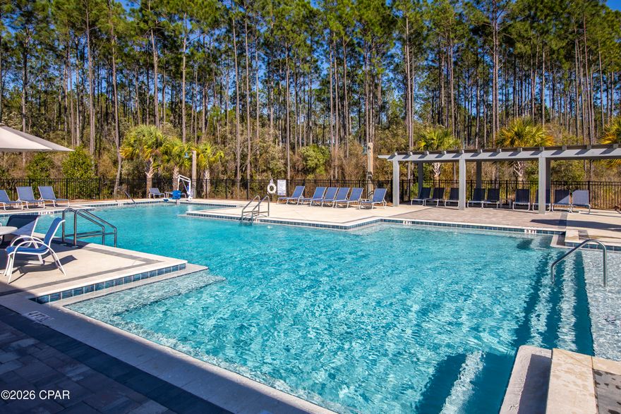 WOW WOW WOW. Privacy Fence, Ceiling Fans, Window Blinds and Irrigation.   New price of $459,900!  Ranch Style Kennedy Plan.  Welcome to Ward Creek, where newer construction meets everyday convenience and a splash of coastal charm. This beautifully maintained 5 bedroom, 3 bathroom home is just 2 years young and offers the perfect blend of space, style, and location.

Step inside to discover a thoughtfully designed floor plan ideal for both lively gatherings and quiet evenings in. With five true bedrooms, there's room for everyone to spread out, create a home office, or host guests with ease. All vynal plank and NO CARPET.  The open living areas flow effortlessly, creating a warm and connected heart of the home.

Practical features shine here. The spacious 2-car garage includes built-in shelving for additional storage, and you'll appreciate the approximately 100 sq ft of attic storage space, giving you even more room to stay organized without sacrificing living space.

Out back, enjoy rare privacy as the property backs up to wooded wetlands, offering a peaceful natural backdrop where no one can build behind you. The fenced backyard is perfect for pets, play, or relaxing evenings outdoors. A sprinkler system keeps the lawn lush, while the landscaped front yard enhances the home's curb appeal.

Location is the golden key. You're minutes from the Tallahassee Memorial HealthCare Center, approximately 15 minutes to Northwest Florida Beaches International Airport, 10 minutes to the shopping, dining, and entertainment at Pier Park, and just 15 minutes to the white sandy beaches of Panama City Beach.

Ward Creek residents enjoy a neighborhood pool, park, and direct access to a walking and biking trail, making it easy to embrace the Florida lifestyle right outside your door.

Nearly new. Private backdrop. Exceptional storage. Prime location. Ready to welcome you home.