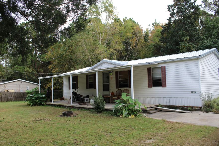 This mobile home is in very good condition. It features a beautiful nearly half acre lot. It is centrally located to shopping, hospital, parks and Tyndall Air Force Base. There is a fenced dog kennel and a workshop outside with coverd storage. A nice open front porch has many possiblities for you to put many things to decorate your new home. Best deal in the neighborhood. Home has been taken care of very nicely.