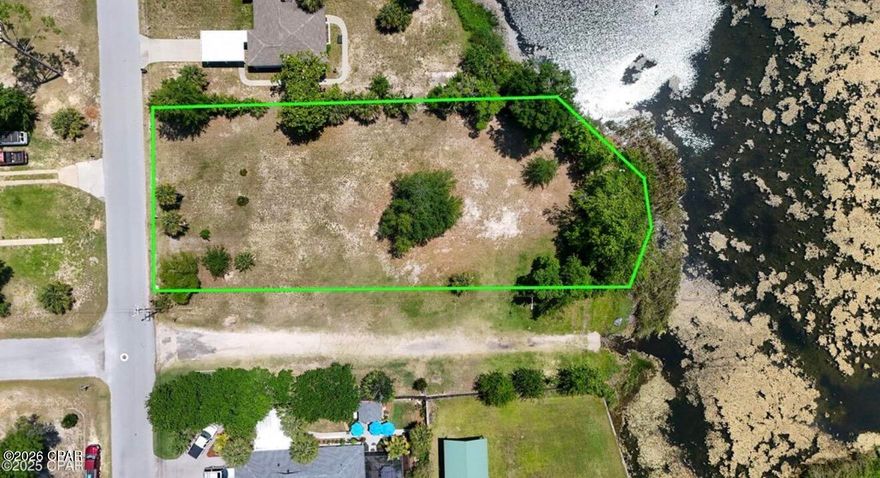 Discover a rare opportunity to build your dream home in the heart of one of Bay County's most desirable communities. 902 Iowa Avenue offers an exceptional 0.54-acre homesite with tranquil water views, creating the perfect canvas for a private coastal retreat while still being moments from everything that makes Lynn Haven so special.

Tucked into a peaceful residential setting, this property combines space, scenery, and lifestyle. Imagine designing a custom home surrounded by mature trees and calming water views, where mornings begin with coffee overlooking the water and evenings end with breathtaking sunsets across the bayou.

For families and outdoor enthusiasts, the location is simply unmatched. Just minutes away is Sharon Sheffield Park, the crown jewel of Lynn Haven's park system. This beautiful waterfront park features playgrounds, walking trails, shaded picnic areas, sports courts, and a vibrant amphitheater that hosts community concerts, movie nights, and seasonal festivals throughout the year. It's the kind of place where families gather, kids play freely, and neighbors become lifelong friends.

Boating and waterfront recreation are part of everyday life here. Just a short drive away is Porter Park, offering one of the area's most convenient public boat ramps with quick access to North Bay and the beautiful waterways of the St. Andrews Bay. From fishing trips and sunset cruises to paddleboarding and kayaking, endless coastal adventures begin just minutes from your doorstep.

Beyond the water and parks, the property sits in the heart of the thriving community of Lynn Haven, known for its tree-lined streets, strong schools, and welcoming small-town atmosphere. Residents enjoy convenient access to local restaurants, boutiques, and everyday amenities along State Road 77, while the sugar-white beaches of Panama City Beach and the dining, shopping, and entertainment of Panama City are just a short drive away.

With over half an acre of land, peaceful water views, and proximity to parks, boat ramps, and vibrant community spaces, 902 Iowa Avenue offers more than just a homesite--it offers a lifestyle. A place where family memories are made, weekends are spent on the water, and the best of Florida living surrounds you every day.
