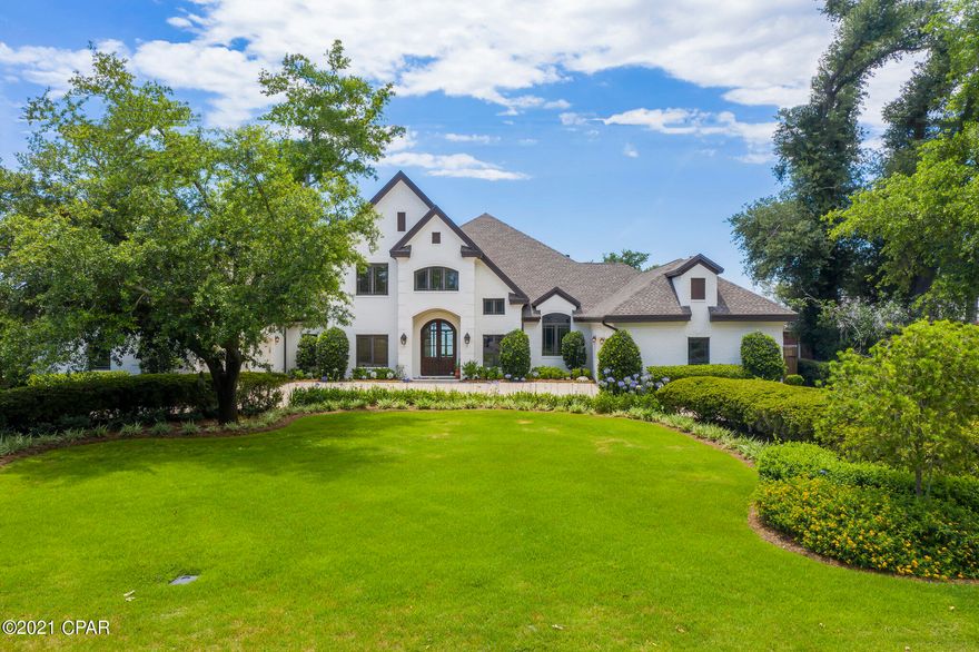 The views from this spectacular home are unsurpassed. Imagine the most beautiful sunset over St Andrew's Bay from your own backyard. Picture relaxing by your swimming pool watching the sea gulls  and pelicans dive for their catch while the dolphins play. This is a one-of-a-kind home sitting on perhaps the highest elevated lot on Bunkers Cove Road with approximately 130 feet of deep water frontage on St Andrew's Bay.



This nearly 7000 square-foot home includes five bedrooms, 6 1/2 bathrooms, 4 covered porches, a fitness center with a steam shower, a media/movie room, a five car garage with a Tesla charging station, an elevator, floor sweeps, stunning 12 foot high ceilings, four gas fireplaces, and panoramic views of Saint Andrews B the 10 foot high solid mahogany doors of this custom built home, you are greeted by a breathtaking open foyer with an opulent floating staircase, beautifully designed columns, hardwood floors, and a sitting area with floor to ceiling windows to showcase views of St Andrews Bay.

Step into the kitchen and enter a chefs dream- the luxury kitchen is seamlessly designed with gorgeous custom wood cabinets, dual islands ( one with a breakfast bar), plenty of storage, a walk-in pantry, a 48 inch  Subzero  refrigerator/freezer,  a Dacor six burner gas cooktop, a wolf built-in wall oven, double microwaves,  and 4 Fisher Paykel drawer dishwashers. This stunning kitchen will not fail to impress. Imagine what you could do in this kitchen which opens to the family room and dining area  for a wonderful layout for entertaining or just enjoy every day living.  Immediately off the kitchen is a Butler's pantry with a wet bar, an ice-maker, and additional storage.

The master bedroom is complete with detailed ceilings up to 12 feet tall, a separate sitting area with Bay views, a gas fireplace and extra large his and her  walk-in closets.  The en-suite master bath has heated tile floors, a Jacuzzi tub with air bubblers, a gas fireplace, custom etched glass window, a towel warming drawer, two TVs, and an outdoor shower. Wow!

On the first floor, you will find two additional bedrooms each with a full bathroom and private access to separate covered porches. One of the bedrooms has a private entrance down a paver walkway from its own parking.

There is a fitness center which could be used as a six bedroom, it includes a full bath with a steam shower and private access to the pool.  Separate his and her private offices with built-in floor to ceiling cabinetry and a billiard room/formal dining room complete the first floor.

Take the elevator upstairs to find two additional bedrooms with en suite baths and a large media room with a built-in kitchenette. From the media room walk onto a large covered balcony to breathtaking views of Saint Andrews Bay.

Houses like this rarely come available. Don't miss this opportunity to own an incredible home, with the best views in Panama City Florida.