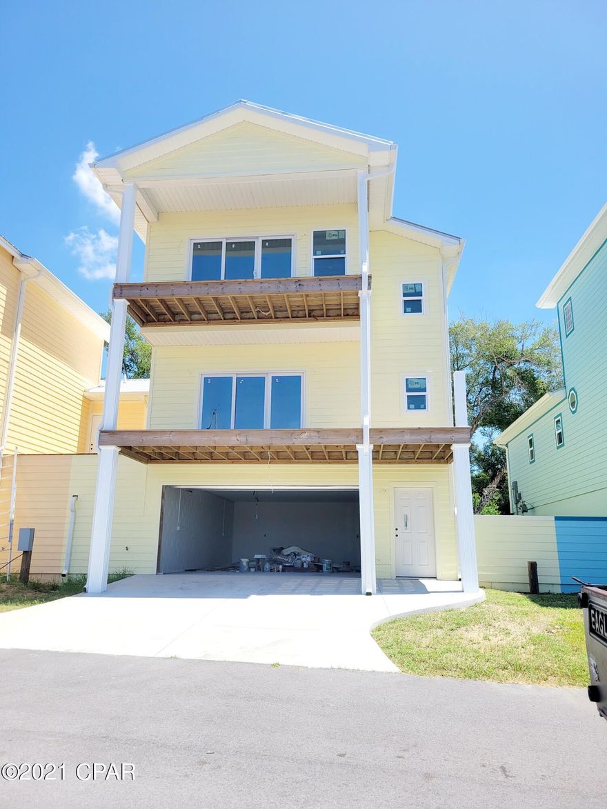 Gated Neighborhood with magnificent West Sunsets which can be enjoyed  from this beautiful home while you relax in the comfort of your living room and kitchen. or the Master Suite! There are 3 levels with 1 large deck off the main living area and a second deck off the master bedroom. The views are spectacular overlooking the boats and the privatly owned marina on the Bayou. This home is nearly completed and ready to move into soon! Ground floor is a enclosed concrete block garage and extra enclosed air conditioned room for shop, guest room or multiple uses. Main floor has kitchen, dining living room and two bedrooms. Top floor is the master suite. Elevators can be added to construction.