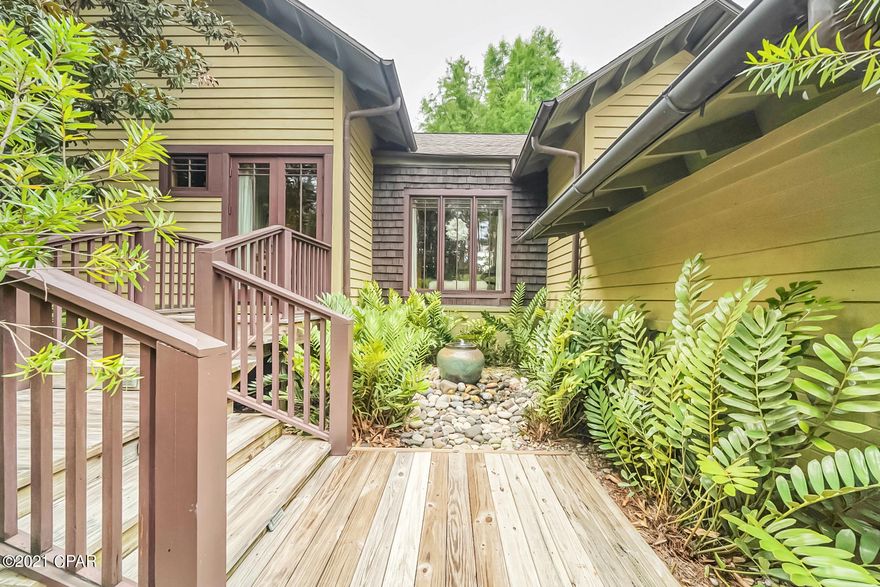 Own your own private resort-like oasis and spa as you cross your own private bridge into a secluded sanctuary. This exquisite, custom built and hand crafted luxury home, has impeccable architectural characteristics and comes complete with the utmost details, including a 10 foot mahogany front door, slate flooring through an impressive foyer which gives way to a two-sided gas fireplace with a custom mantle between the grand dining and living rooms that showcases beautiful hardwood flooring, tremendously high ceilings that complete the whole house, floor to ceiling windows in the massive living room that overlooks the backyard oasis, a resort style pool with a custom stone waterfall and planters and the many decks that overlook the 8th hole of the acclaimed Greg Norman's Shark's Tooth Golf Course. The gourmet kitchen boasts Sub Zero refrigerator/freezer, Wolf gas six burner/double oven with Viking pro series range hood, two Asko dishwashers, a sub-zero wine cooler and the kitchen boasts a 12'x4' large marble island. There are cedar lined master closets off of the magnificent master bedroom and the master bathroom features tile floors, deep garden tub, a large glass shower with body sprayers, back-to-back travertine vanities and a unique double-sided mirror. There is a beautifully custom mahogany spiral staircase that leads to an extra bedroom or study and two guest bedrooms with ensuites are located on the other side of the house, giving everyone privacy and access to the backyard. More upgrades include a fully finished, climate controlled two-car garage plus separate golf cart garage, two Rinnai tank-less water heaters, copper gutters, 8' tall solid wood doors, media room with electronics and Sonos System with speakers throughout. The Gated Wild Heron community has a gorgeous pool, Fitness Center and Boat House on Lake Powell for everyone's enjoyment. This famously known gated community is just minutes from Rosemary Beach, 30A, six miles from the future University Hospital and only a mile and a half from the beautiful Gulf of Mexico!