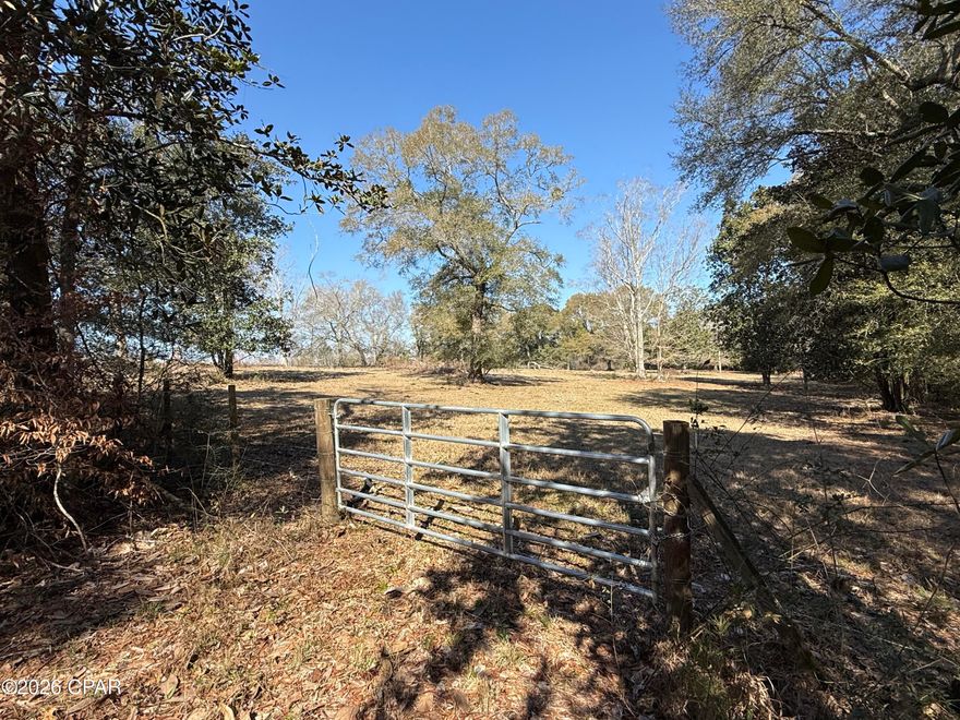 Paved Road Frontage buffered by Trees for privacy. This 10ac parcel is PERFECT for your next Home and/or Hobby Farm. Mature Majestic Oaks present this primarily open land in an inviting light for your home and wildlife. The gently sloping elevation adds character on this 100% upland tract.