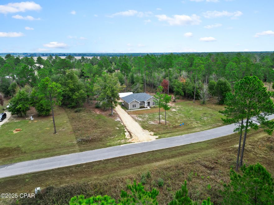 Brand-new 2025 construction on 1.96 acres in the highly sought-after Blue Springs Plantation subdivision! This beautifully designed 3-bedroom, 2 bath home features durable Hardie Board siding, a modern, open layout with LVP flooring, granite countertops, soft-close cabinet drawers, and 9-ft and 12-ft ceilings that create a bright, spacious feel. The kitchen features stainless steel appliances and a functional layout perfect for everyday living.

The home includes large bedrooms, double vanities in the bathrooms, a covered back porch for relaxing outdoors, and a detached 2-car carport. Enjoy almost 2 acres of peaceful living while staying close to town.

Located just minutes from the popular Blue Springs Park and about 15 minutes from Marianna schools, this home offers the perfect blend of privacy, convenience, and high-quality new construction.

Move-in ready and built to last—this one won't last long!
