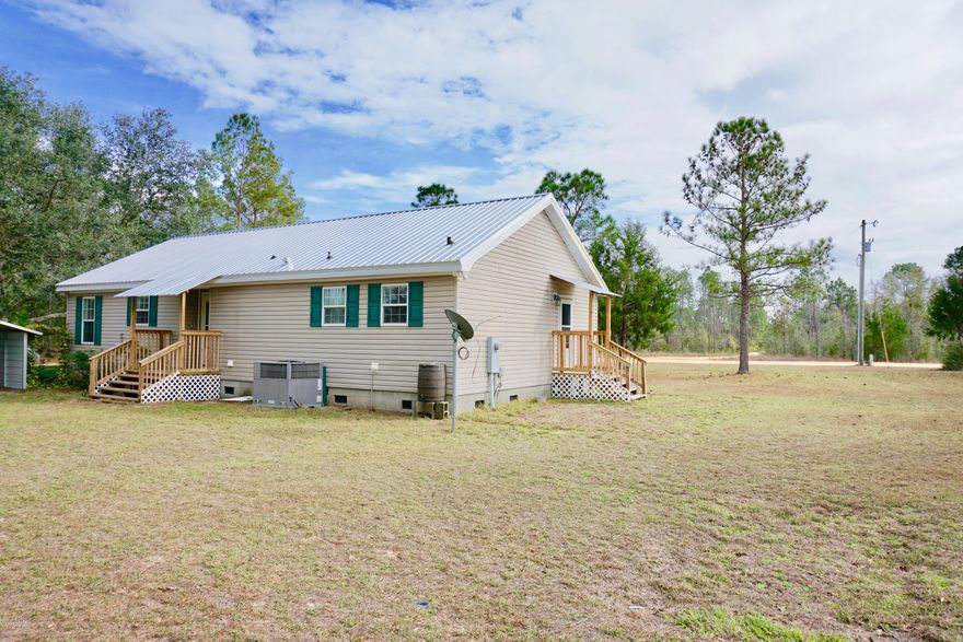 This is a very nice modular home located in beautiful Compass Lake Hills.  There are two outbuildings and a detached carport.   Enjoy the amenities that Compass Lake in the Hills has to offer, some of which include access to two lakes, clubhouse facilities, golf driving range, cabin rentals and more!