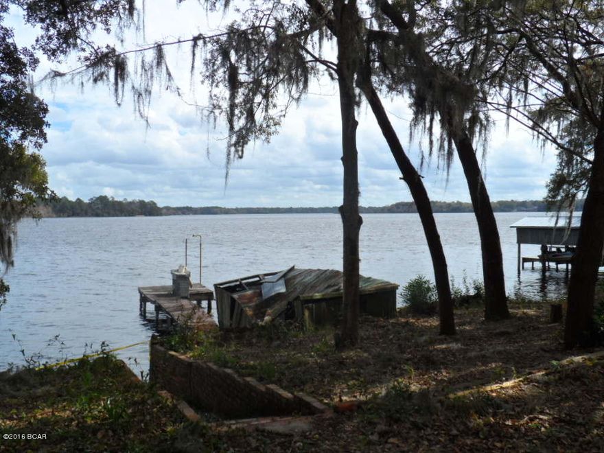 WATERFRONT ACRE looking high above BEAUTIFUL DEER POINT LAKE. This diamond in the rough is waiting to be brought back to it's original charm. It is approx 1500 sq feet of original heated and cooled space but has almost 2100 under roof. It needs extensive renovations; Roof, Central H/A, Replacement of Galvanized Pipes and Septic System , Dock and Boat House repair, and refinishing of original hard wood floors. Even with these repairs, this property has incredible potential and loads of out door space.