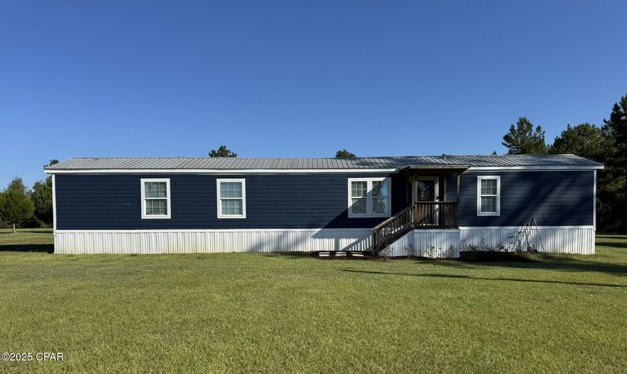 CURRENTLY UNDER CONTRACT, SELLER WILL CONSIDER BACKUP OFFERS Completely remodeled, this refreshed and immaculate three-bedroom, two-bath residence awaits your arrival. Inside, appreciate the crisp, clean aesthetic with ample kitchen cabinetry, and a master bathroom with a bonus of a separate shower and tub. Notable features include a metal roof and a modern HVAC system installed in 2022. Situated on 2 1/2 acres of meticulously manicured lawn, the property is partially fenced and showcases a spacious deck adjacent to the rear entrance. Furthermore, the residence benefits from durable Hardy Board siding, ensuring enhanced resilience. Located in a serene rural setting, yet 3 miles from Walmart and various shopping, dining, and hospitality amenities.