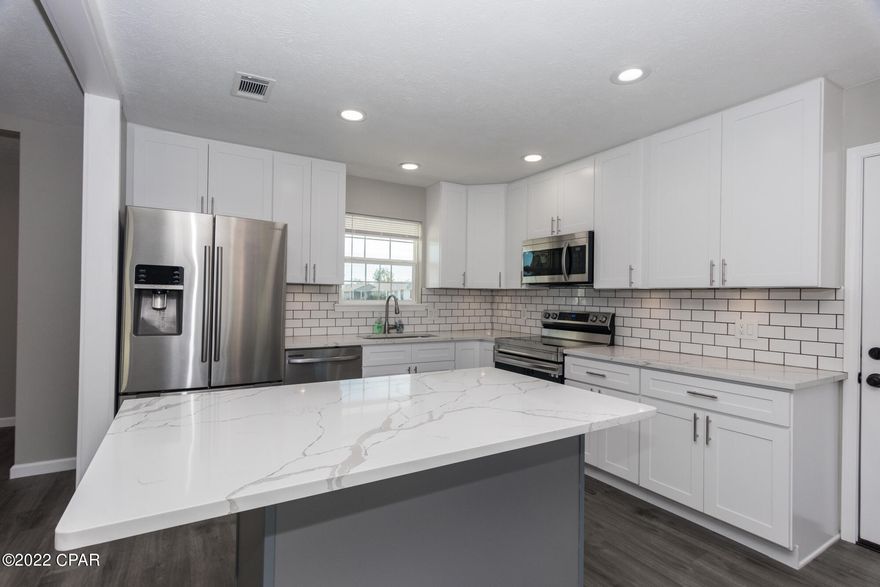 CURRENTLY UNDER CONTRACT, SELLER WILL CONSIDER BACKUP OFFERS. Updated Lynn Haven home feels like new and located near numerous parks, trails, and boat launches that access the Bay and Gulf of Mexico! Walk to Cain Griffin Park with a playground, splash pad, tennis and basketball courts, and ball parks. No HOA and No Flood Zone here. 

You'll appreciate the updated and modern interior with open living area showing off your new kitchen with island, gorgeous quartz countertops, all new soft close drawers and cabinets, subway tile backsplash, cabinet underlighting, and stainless steel appliances. Sturdy and attractive Armstrong luxury vinyl plank flooring throughout, new air conditioning, wood burning fireplace, new lighting fixtures, new paint, and updated baths. Master bedroom features a tiled walk-in shower, new vanity, and a walk-in closet. 
Exterior updates include new windows, doors, and vinyl siding. Gutters already installed! Inviting front covered porch, and a relaxing open patio at the rear. Spacious backyard with room for a pool or additional storage and no immediate neighbors behind you. Public water and sewer. Great location near shopping, dining, parks, top rated schools, and so much more.  You don't want to miss this opportunity to own this like new home in cozy, convenient Lynn Haven.

Buyer to confirm all aspects of lot size, location, feasibility, improvements, etc