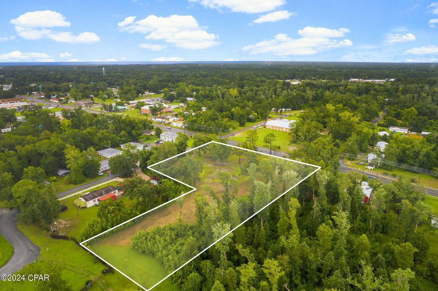 Seize the incredible opportunity to own 3.56 acres of prime commercial property located on Highway 71. This spectacular parcel, nestled on a massive corner lot, has been meticulously cleared for development, offering a serene landscape adorned with mature oak trees. Situated on Highway 71, this property boasts 397 ft. of commercial frontage, ideal for high-visibility businesses. Public sewer, water, electric, and gas are readily available, simplifying the development process. This property is perfect for constructing a gas station, restaurant, or local youth center. There is also a potential to develop multiple residential units.  This property is less than a mile from Lake Alice and Lake Julia, and within walking distance to Family Dollar and Rich's Supermarket. A short drive south on Highway 71 brings you to Port St. Joe. A survey is available, providing detailed insights into the property's layout and boundaries. This property presents endless possibilities for commercial or residential development. Schedule your private viewing today and turn your vision into reality on this prime piece of land.