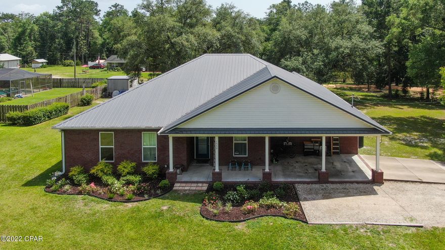 Price Improvement! Expect the unexpected with this nearly new 5 bedroom/ 3 full bath, brick home in the heart of Ponce de Leon, only 30 minutes to the beach and 5 minutes to the clear, ice cold springs for swimming & diving. The split floor plan is open with large rooms and farm house touches throughout, including real engineered hardwood floors. You'll delight in the kitchen with island, pantry, quartz counters & breakfast area (+ formal dining, currently serving as an office). The master suite has a separate retreat area and bath w/ a huge tile shower, double vanity & walk-in closet. The other 4 beds & 2 full baths give you plenty of space for family or guests. Enjoy the large sitting area off the living room also. The back patio has a large oak for shade and gatherings. Welcome home!