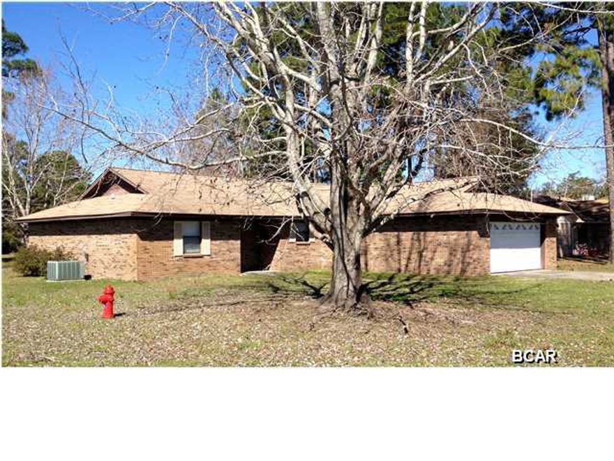Very nice, well-maintained home, on corner lot - convenient to Tyndall AFB. Low maintenance brick exterior, together with a myriad of features inside. Large family room with cathedral ceiling and wood-burning fireplace, opening onto rear patio; fully equipped kitchen, with breakfast bar, and adjacent to large dining area; large master bedroom with double closets, and en suite bath with double sinks and linen closet; two large additional bedrooms; laundry inside; and large garge with plenty of storage - 25'x21'5''. Appointments include fireplace, ceiling fans, tile in kitchen and baths. Thank you for considering this home!