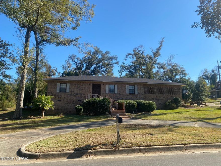 This home has LOTS OF POTENTIAL!  2 bedroom, 2 bath home with an office on a large corner lot.  Located close to Chipola College & Jackson Hospital.  The master bath has a tiled step-in shower.  Open floor plan.  Big laundry room with lots of storage.  New roof was installed October 2018.  Home was leveled by Ducky Johnson, but there are cracks in the brick veneer.  There's work to be done inside the home like sheetrock ceiling repair, floor covering (there's 300 square feet of laminate wood & just under 500 square feet of vinyl tiles brand new in the boxes for you to use), etc.  The screened back porch needs some work.  The dishwasher doesn't work; the refrigerator and stove aren't warrantied.  You can make this a beautiful home!! Being sold AS IS.